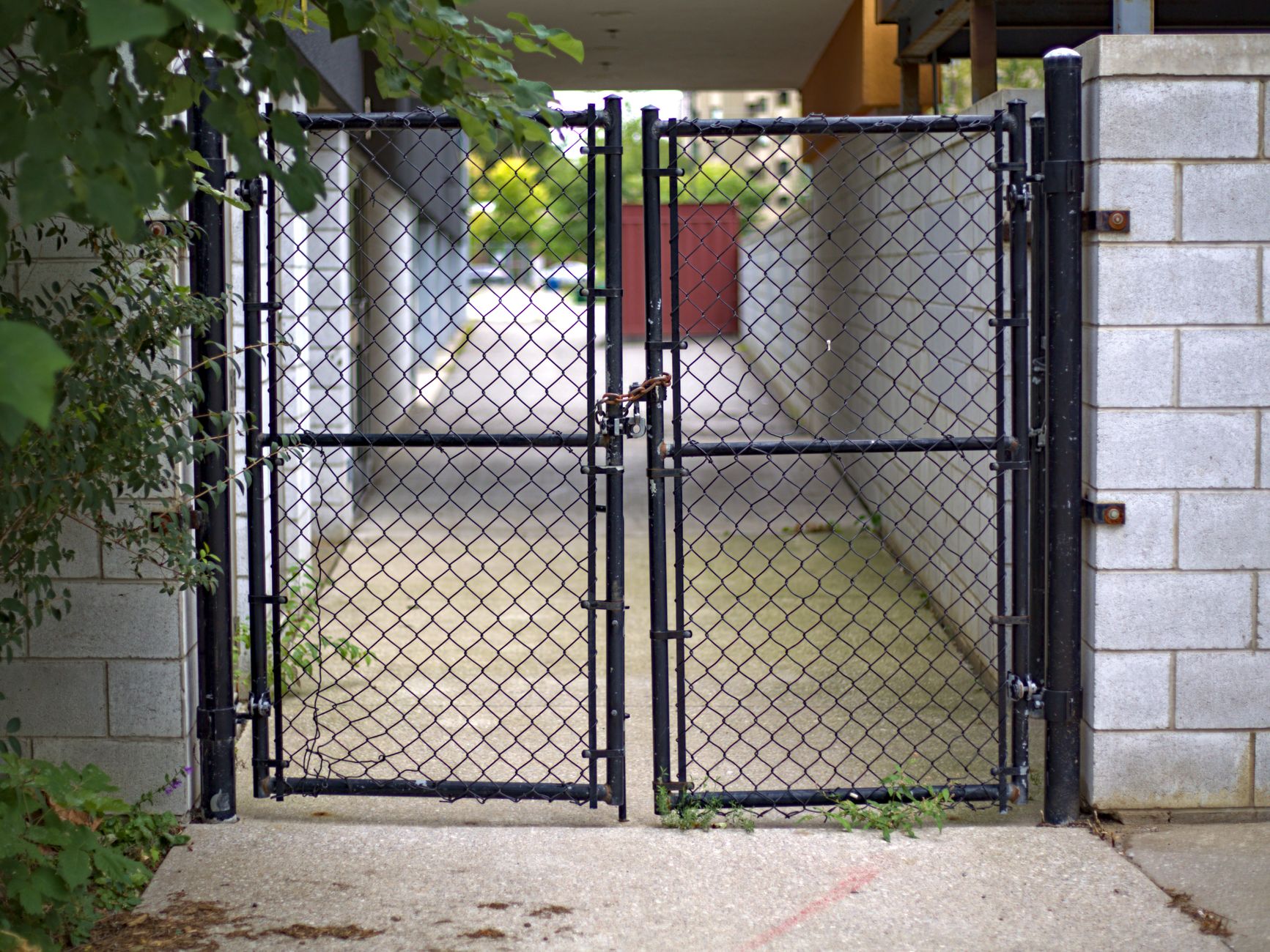 A locked chain link gate in an urban alleyway in Mount Pleasant, SC